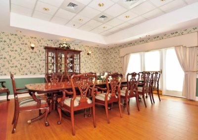 Large dining table with seating for ten and a large china cabinet.