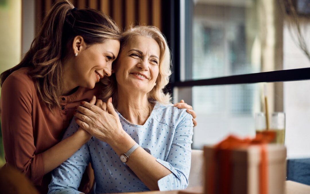 young woman hugging a senior woman