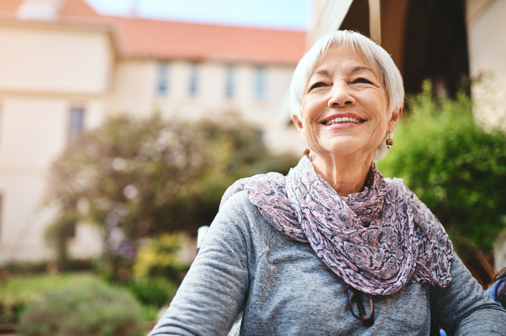 senior woman relaxing outside in the garden of a retirement home