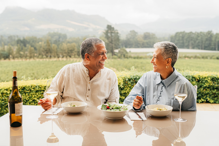 senior couple eating food outdoors