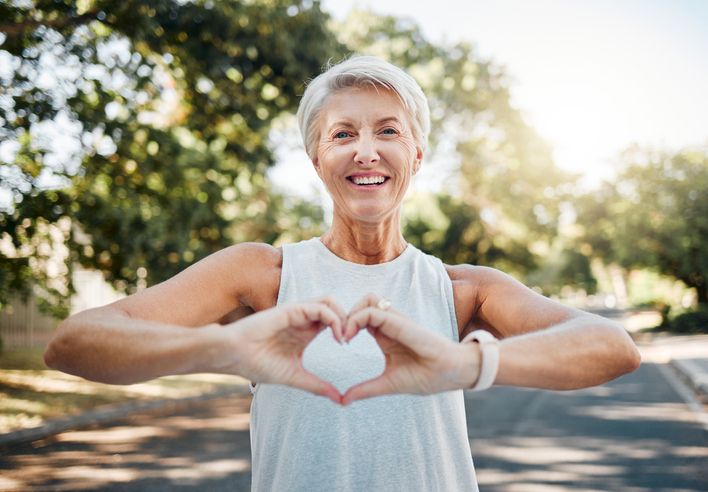 senior woman making a heart with her hands